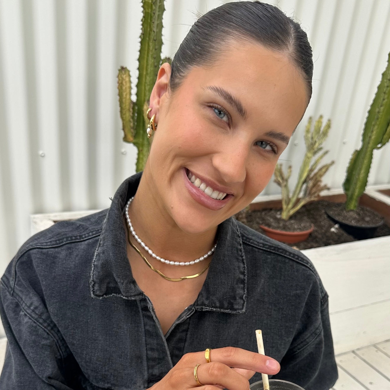 Woman smiling outdoors with cacti in the background