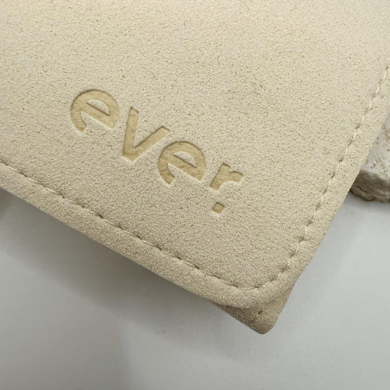 Beige fabric with 'ever.' logo on a light gray background