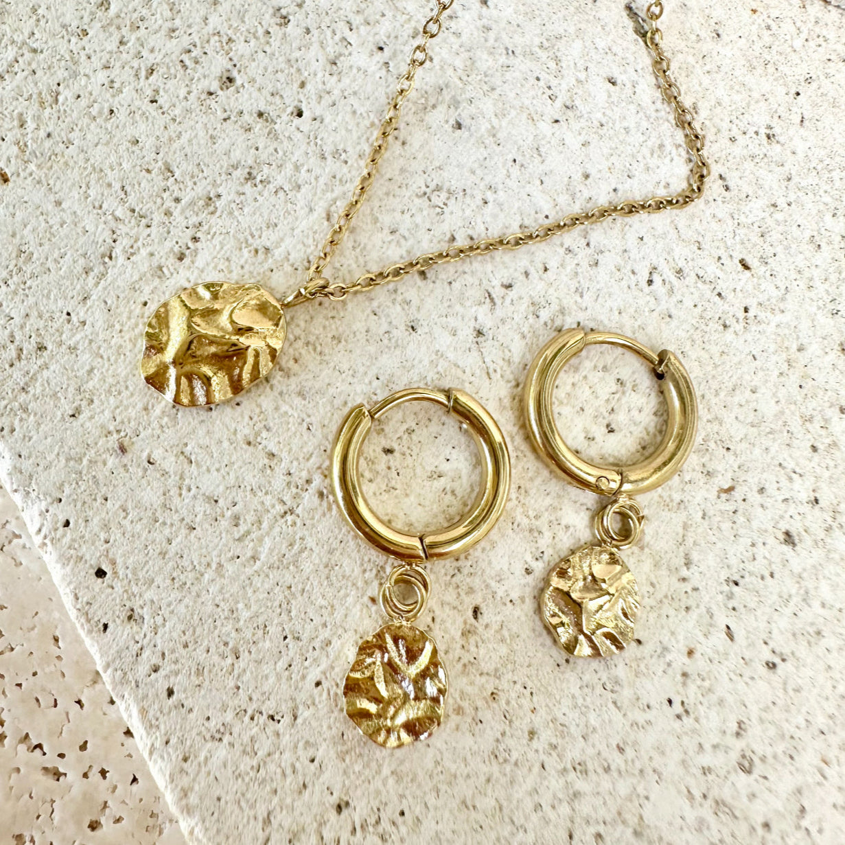 Harmony Gold Huggie Drop Earrings and matching necklace – flat lay showcasing matching waterproof jewellery set.