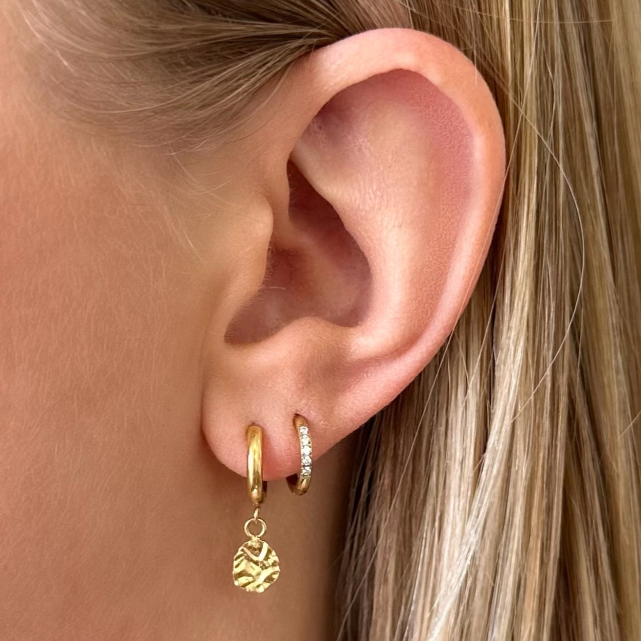 Model wearing Harmony Gold Huggie Drop Earrings – minimal everyday earrings with hammered texture.