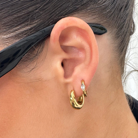 EVER Jewellery’s waterproof Glory Huggie Earrings in emerald, ruby, sapphire, and black – gold anti-tarnish huggies designed for the active lifestyle.