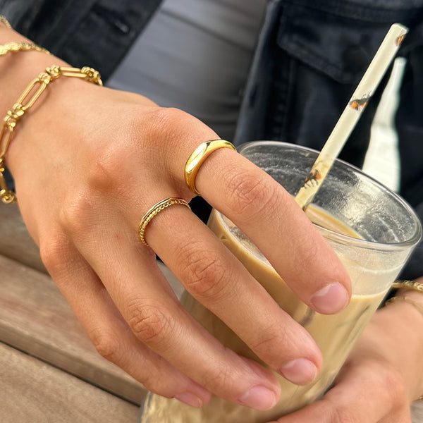 madison-signet-ring-lifestyle-stacked-with-rings-holding-drink-ever-jewellery