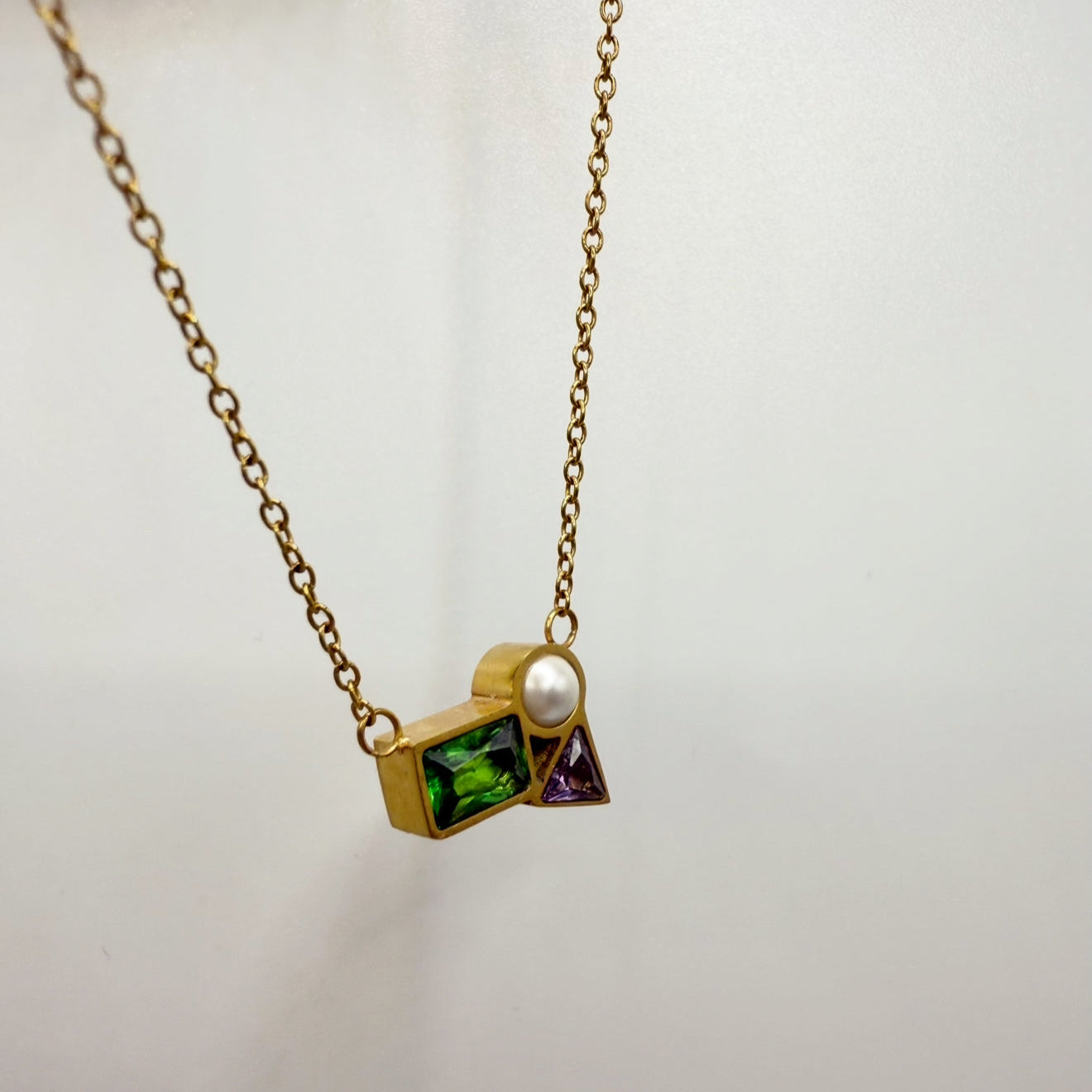 Necklace with geometric pendant on a white background