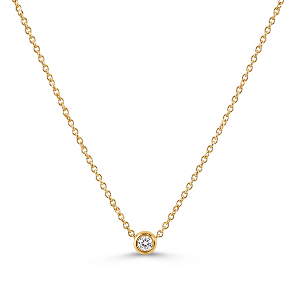 A delicate yellow gold chain necklace with a single bezel-set round diamond pendant, displayed on a clean white background.