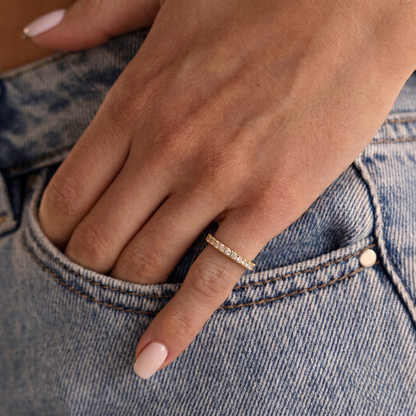 Woman wearing the Rotate Gold Pinky Ring with jeans