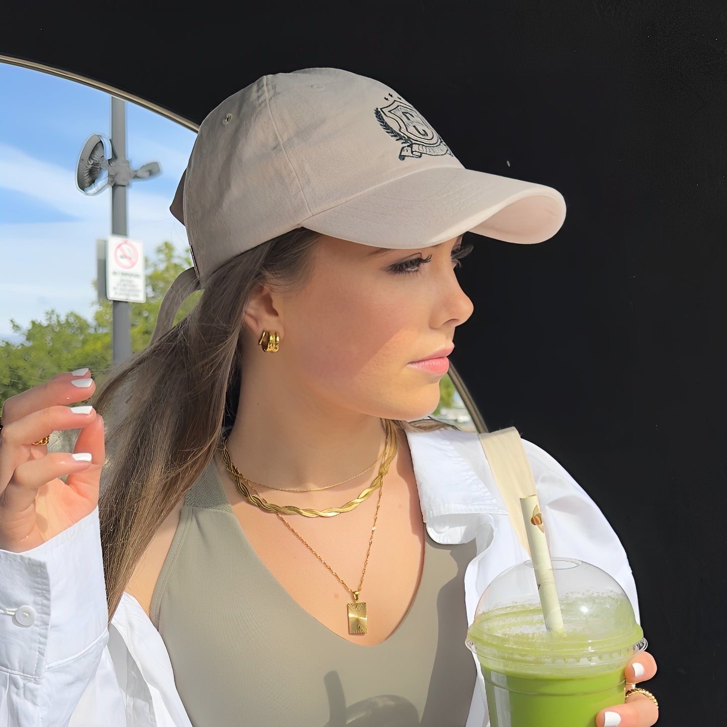 Tempo Hoop Earrings on model in baseball cap and with green smoothie