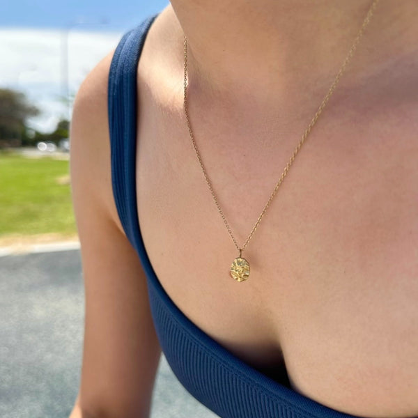 Woman wearing Harmony gold pendant necklace outdoors — waterproof tarnish-free jewellery by EVER