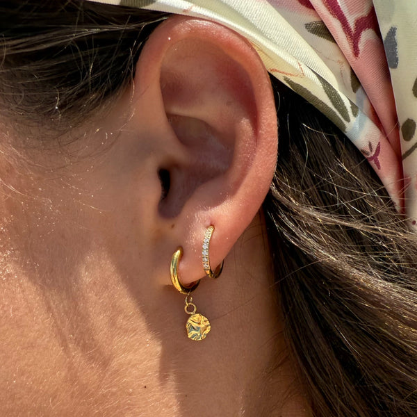Woman wearing Harmony gold huggie earring with headband — everyday waterproof jewellery EVER