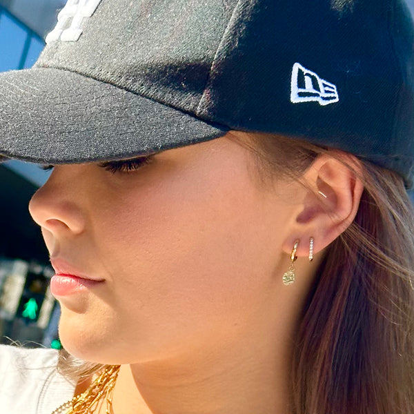 Transition Gold Huggie Earrings on ear - with Harmony huggie earrings - EVER Jewellery