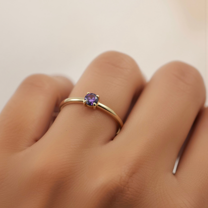 Jaxon Ring Amethyst worn on hand, gold band with amethyst stone
