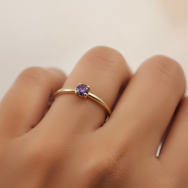 Jaxon Ring Amethyst worn on hand, gold band with amethyst stone