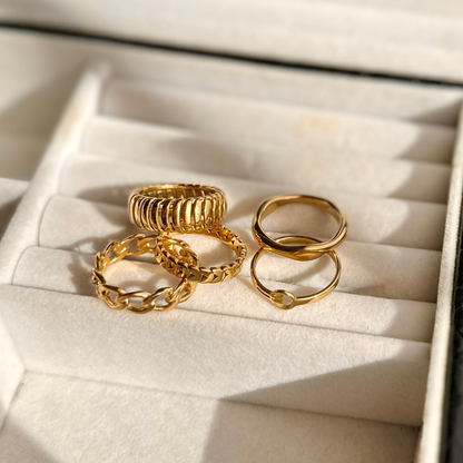 Set of gold rings on a soft, light-colored surface