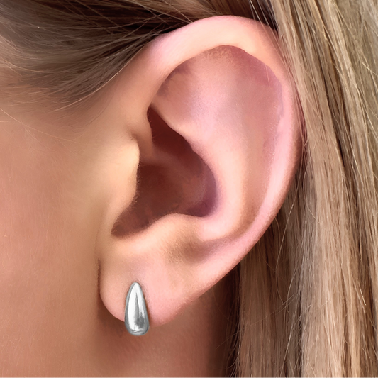 Close-up of_Swift_Silver_Stud_Earrings_on_ear