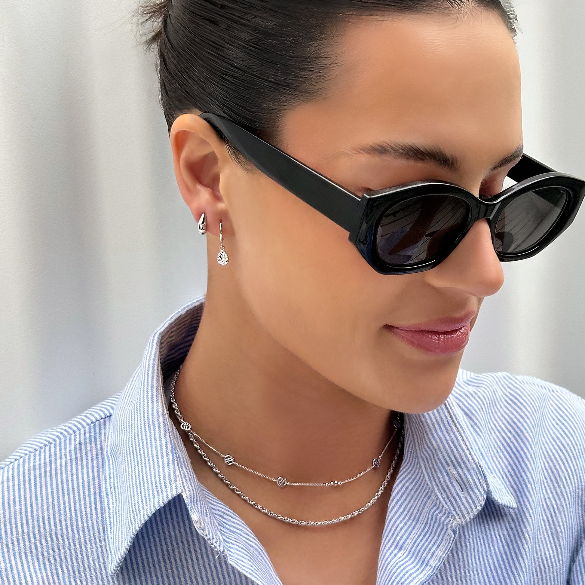 Woman wearing black sunglasses with a blurred background