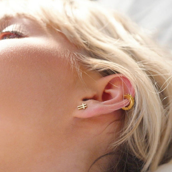 swish-gold-stud-earrings-close-up-on-ear-ever-jewellery
