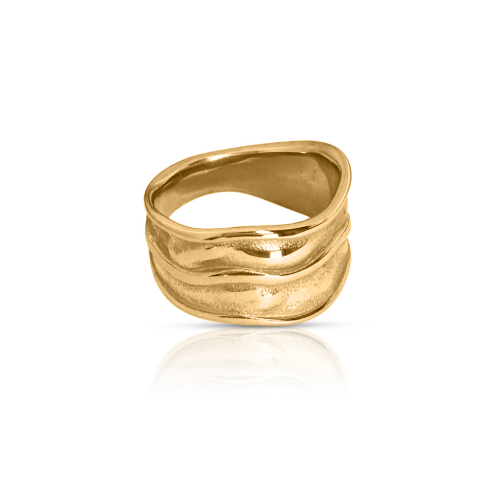 Double Play Ring in gold – sculptural wavy design on clean white background.