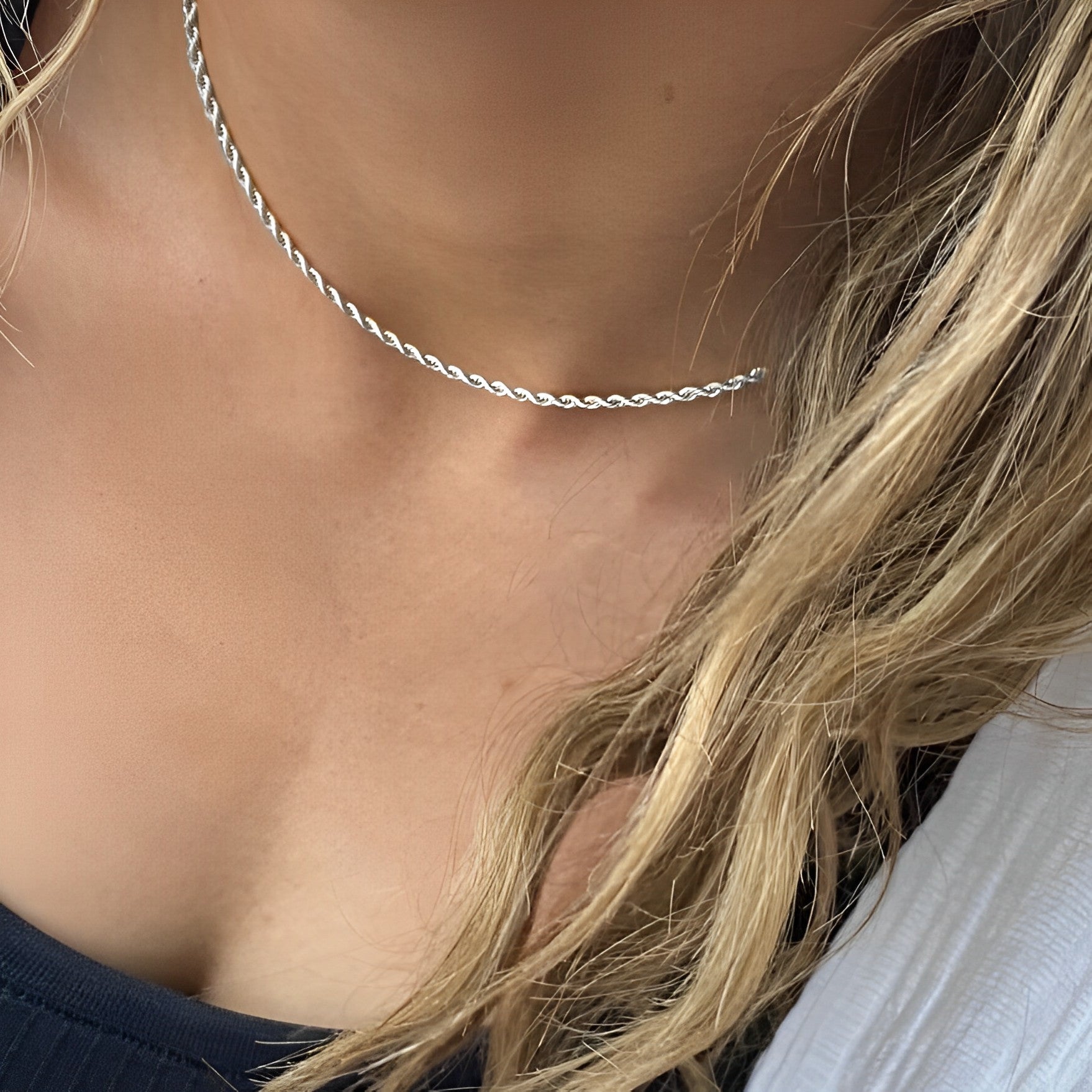 Close-up of Perform Silver Necklace styled solo – rhodium-plated twist chain necklace