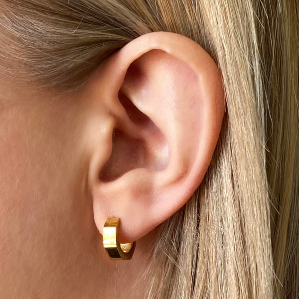 momentum-gold-huggie-earrings-worn-on-ear-close-up-ever-jewellery