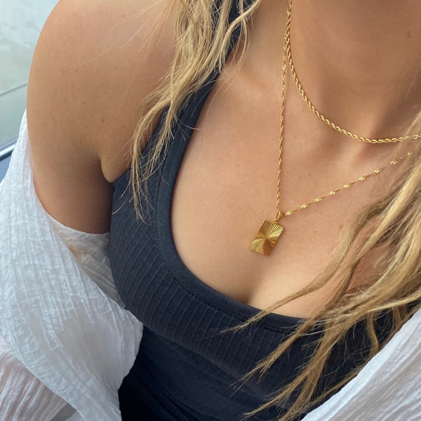 motion-pendant-necklace-worn-on-neck-close-up-ever-jewellery